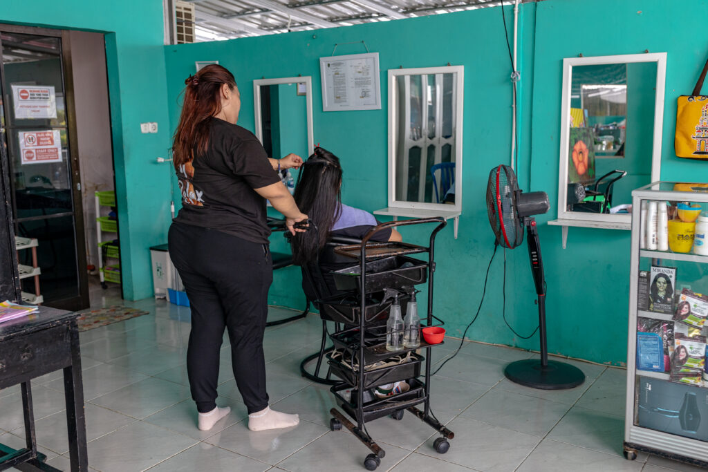 Women inmates at the Bengkulu Women’s Correctional Facility practice hairdressing.